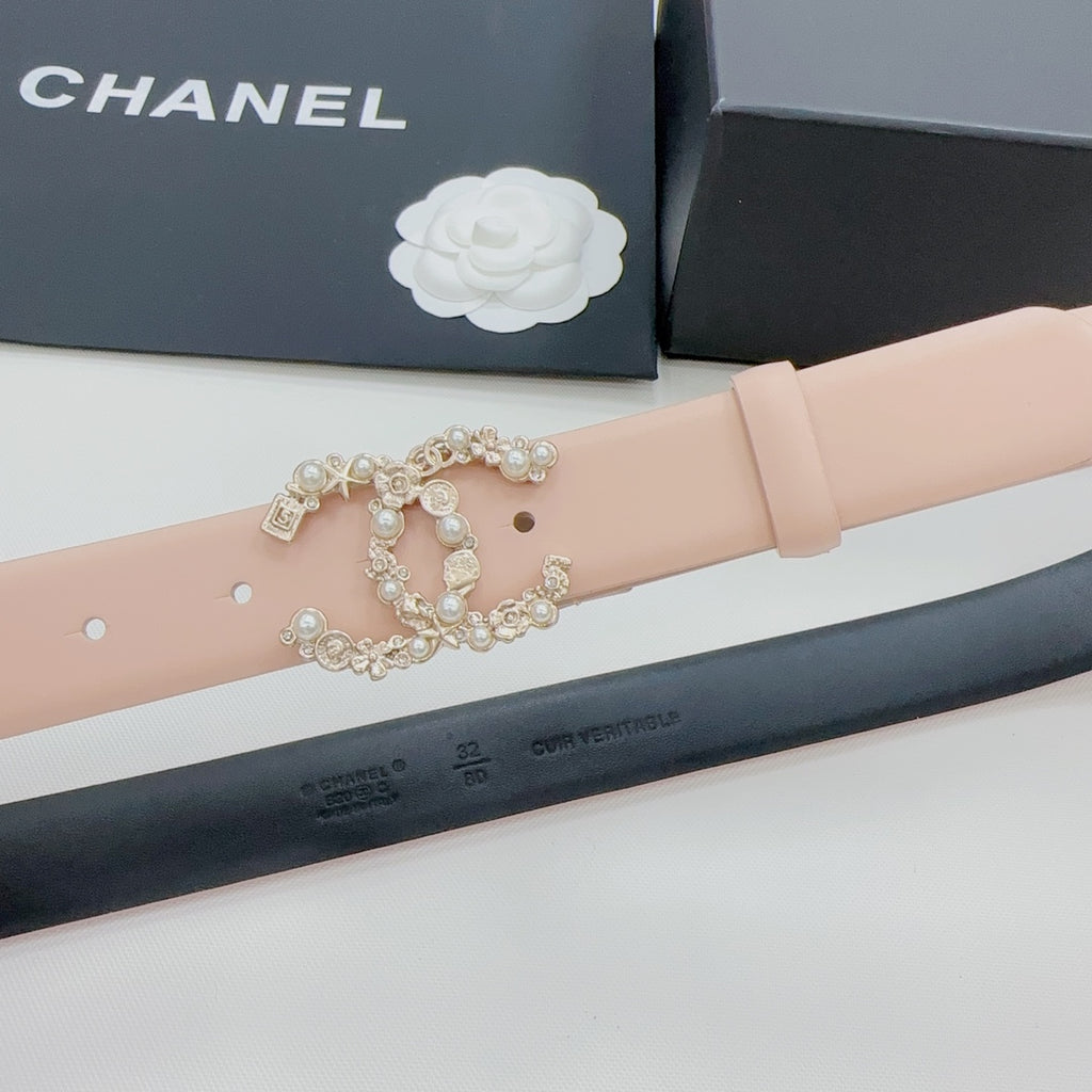 Light pink belt strap with rhinestone buckle and metal studs along the top
