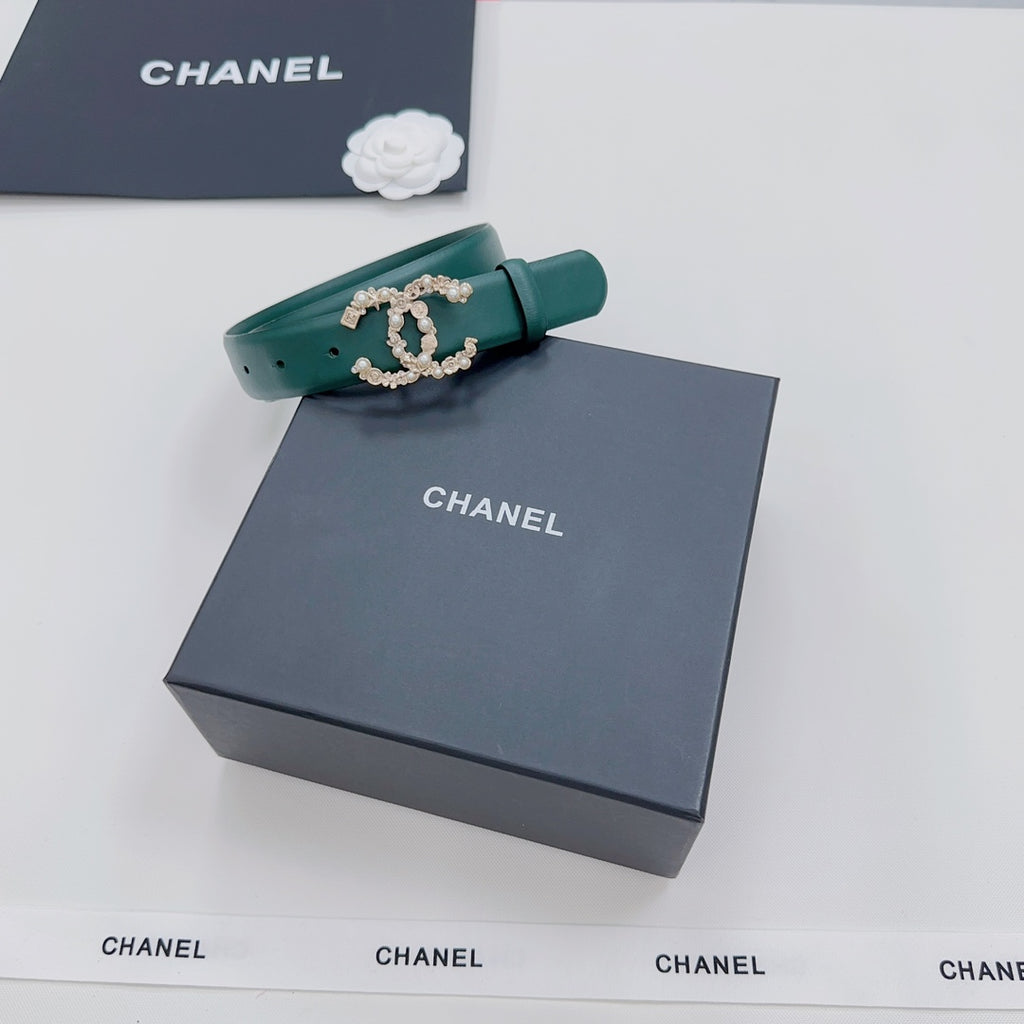 Green Chanel belt with gold and pearl buckle, folded end visible