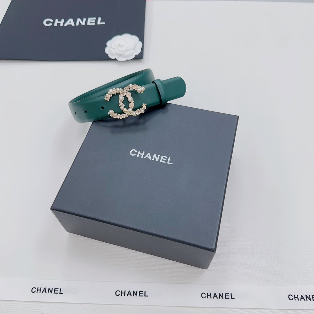 Green Chanel belt with gold and pearl buckle, folded end visible