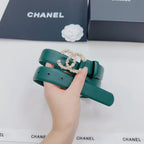 Green Chanel belt with gold CC-style buckle and pearl accents, held upright