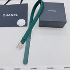 Green Chanel belt with gold and pearl buckle, long strap and keeper shown