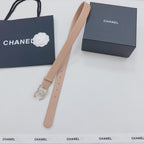 Beige Chanel belt with jeweled buckle, laid out with long strap ends