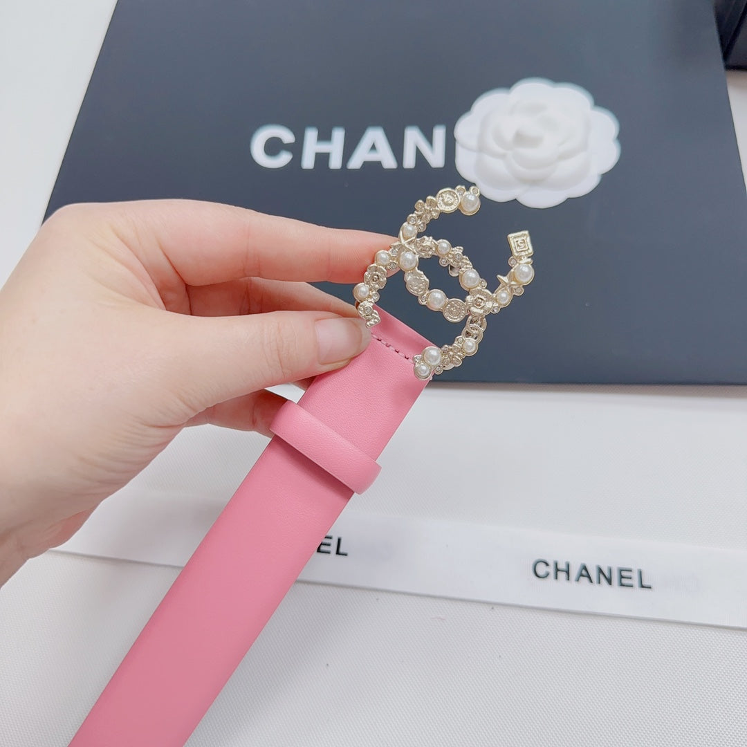Pink leather belt with gold crown ornament and pearl-like ring detail