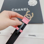 Pink leather belt with gold crown emblem and dark strap end