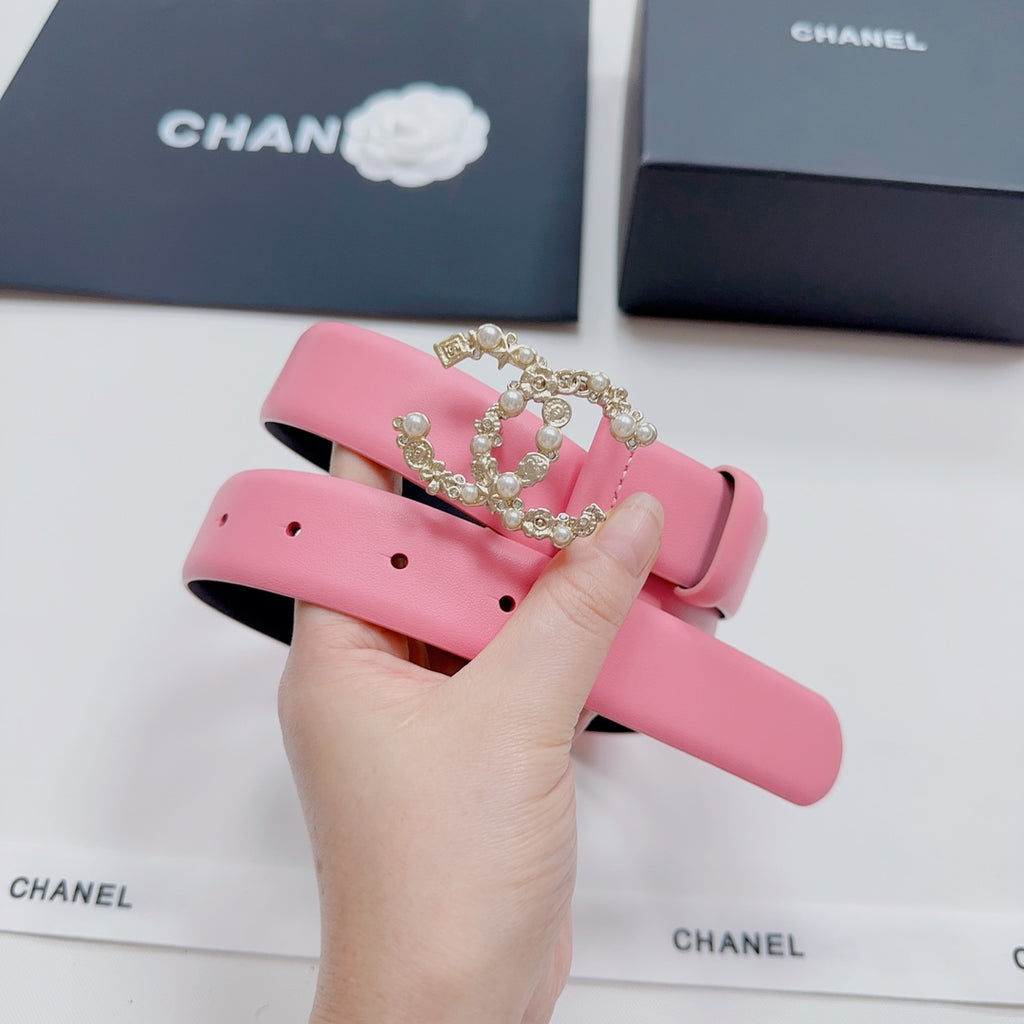 Pink leather belt with gold-tone crown buckle and pearl-like stones