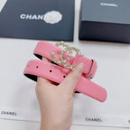 Pink leather belt with gold-tone crown buckle and pearl-like stones