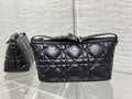 Quilted black Dior bag with top handle, adjustable strap, and clasp closure
