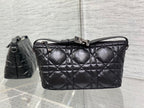 Quilted black Dior bag with top handle, adjustable strap, and clasp closure