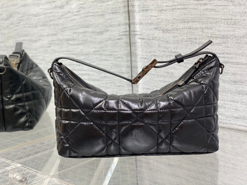 Quilted black Dior bag with zip-top opening and top handle detail