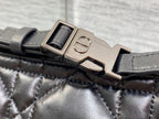 Quilted black Dior bag strap with metal buckle and clasp hardware