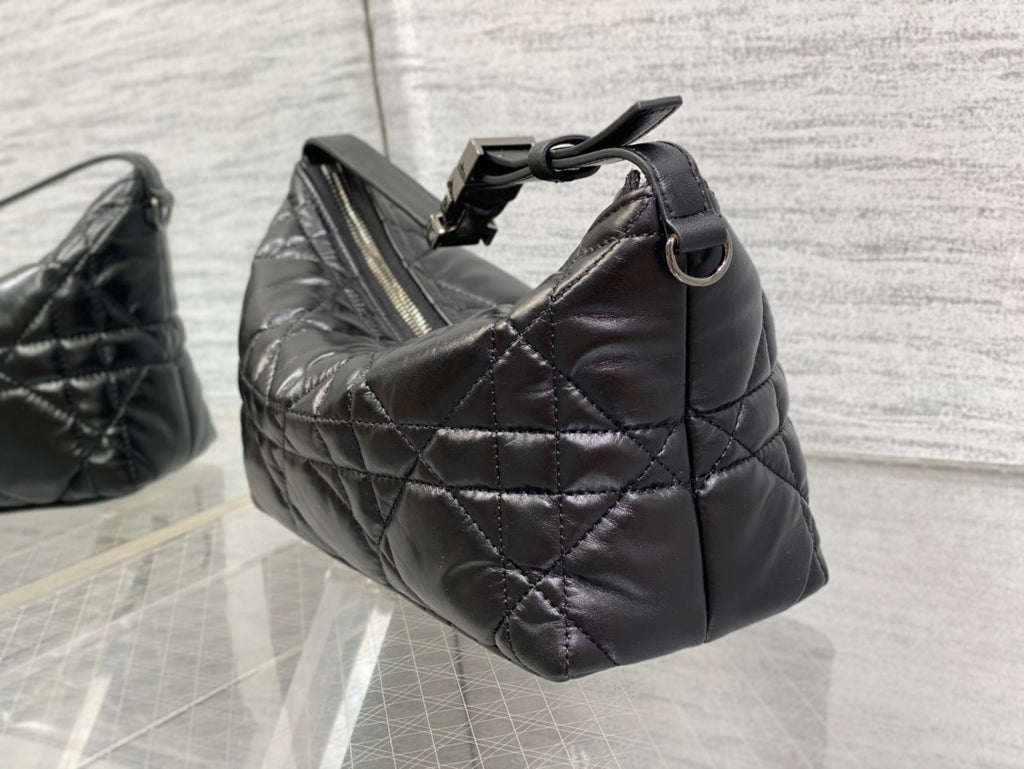 Quilted black Dior bag with top handle and metal ring strap attachment