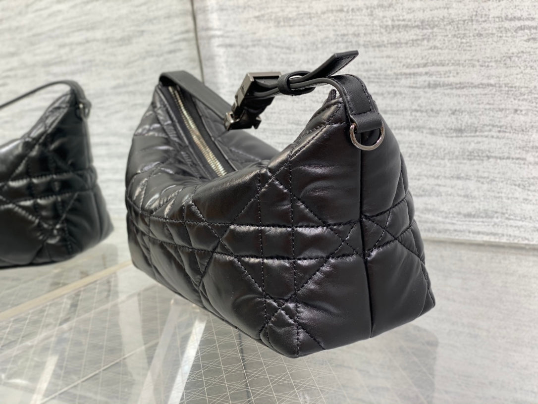 Quilted black Dior bag with top handle and metal ring strap attachment