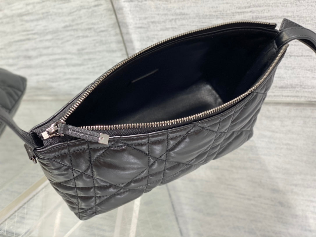 Quilted black Dior bag interior view with gold-tone zipper and dark lining