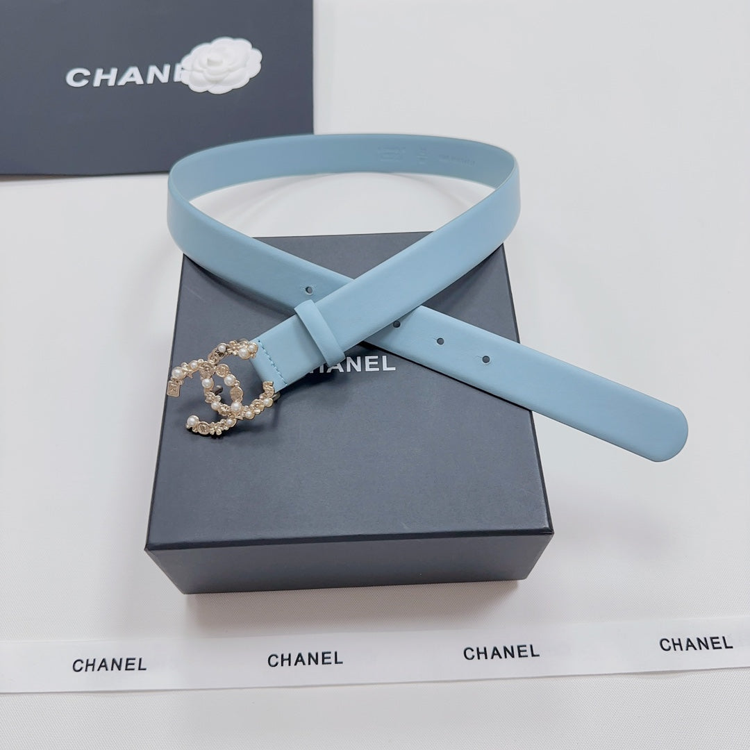 Light blue belt with gold-toned embellished buckle on folded strap