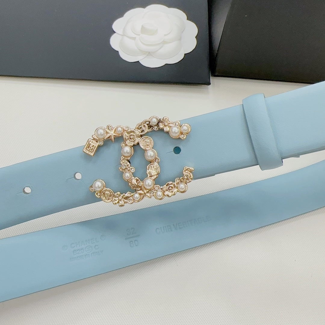 Light blue belt close-up: ornate gold buckle with pearl-like stones