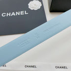Light blue leather belt strap with embossed sizing and branding