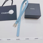 Light blue leather belt with gold embellished buckle and long strap