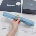 Light blue leather belt with gold jeweled logo buckle