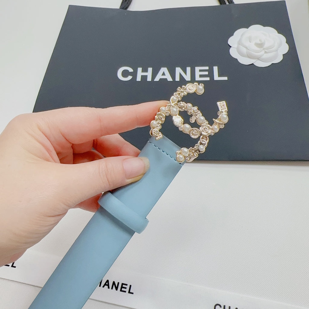 Light blue leather belt with gold CC-style buckle and decorative stones