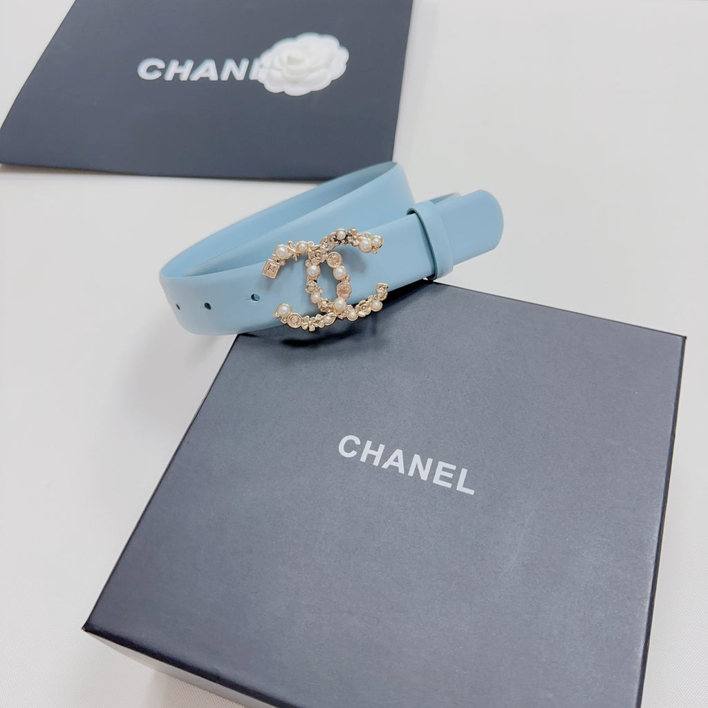 Light blue belt with gold-toned embellished buckle and pin holes