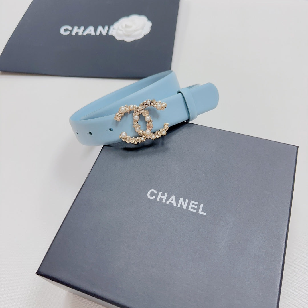 Light blue belt with gold-toned embellished buckle and pin holes