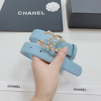 Light blue leather belt with ornate gold CC-style buckle in close-up