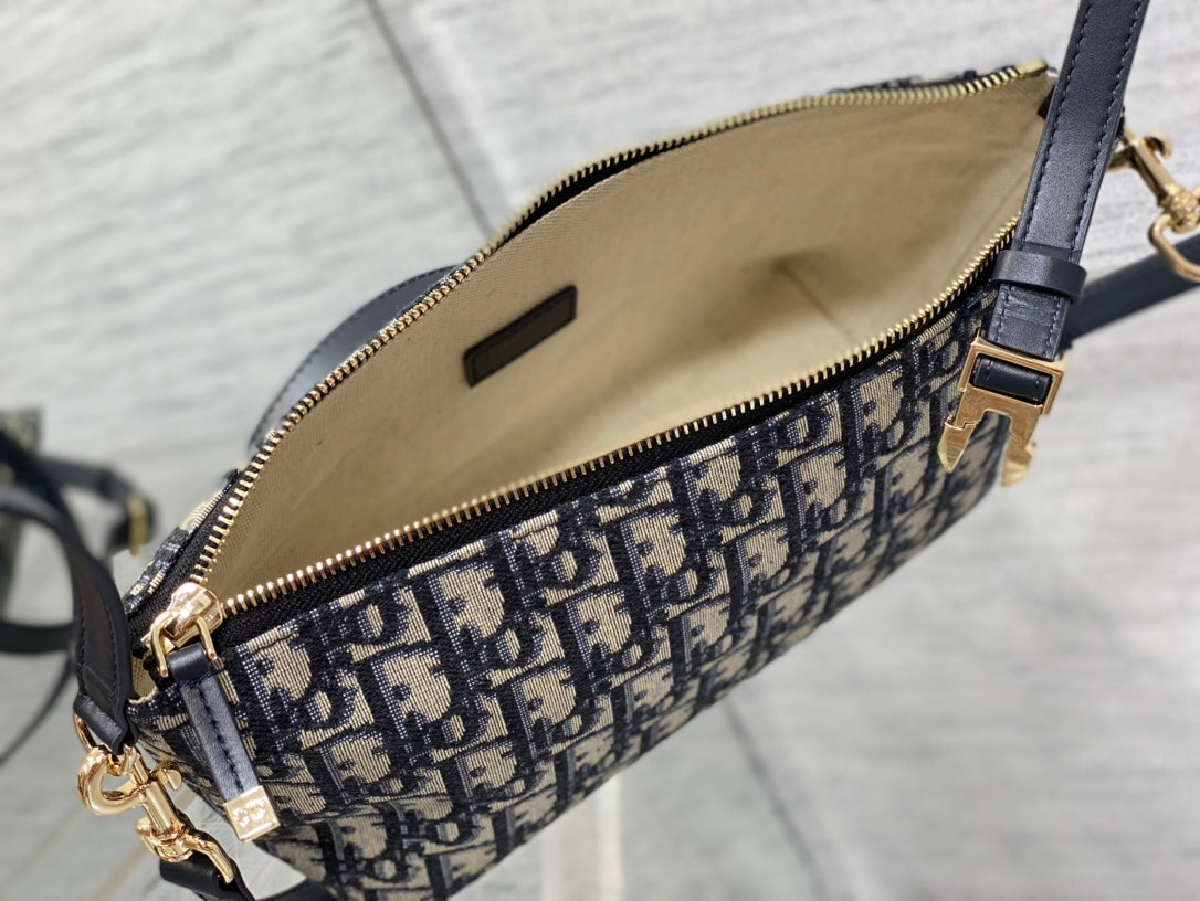 Dior bag interior view with beige lining and navy zippered opening on Dior print canvas
