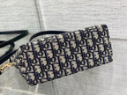 Dior bag side view with Dior monogram print canvas and rolled-top shape