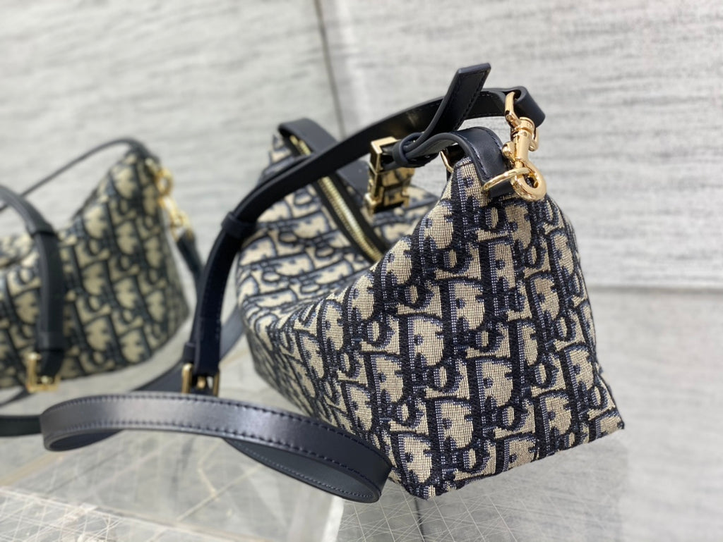 Dior mini hobo bag with Dior print canvas, navy handles, and gold hardware details