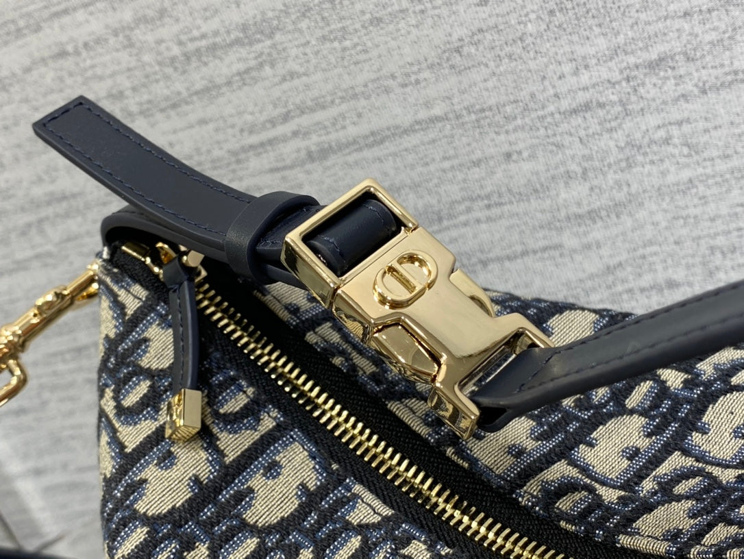 Dior monogram bag close-up of front strap buckle and gold-tone hardware, zipper track