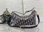 Dior hobo bag in Dior monogram canvas with navy leather trim and gold buckle strap