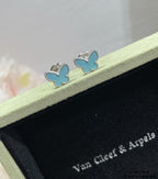 Blue butterfly stud earrings with silver-tone borders shown in open gift box.