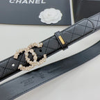 Chanel belt detail: dark quilted leather with gold buckle and pearl-embellished clasp