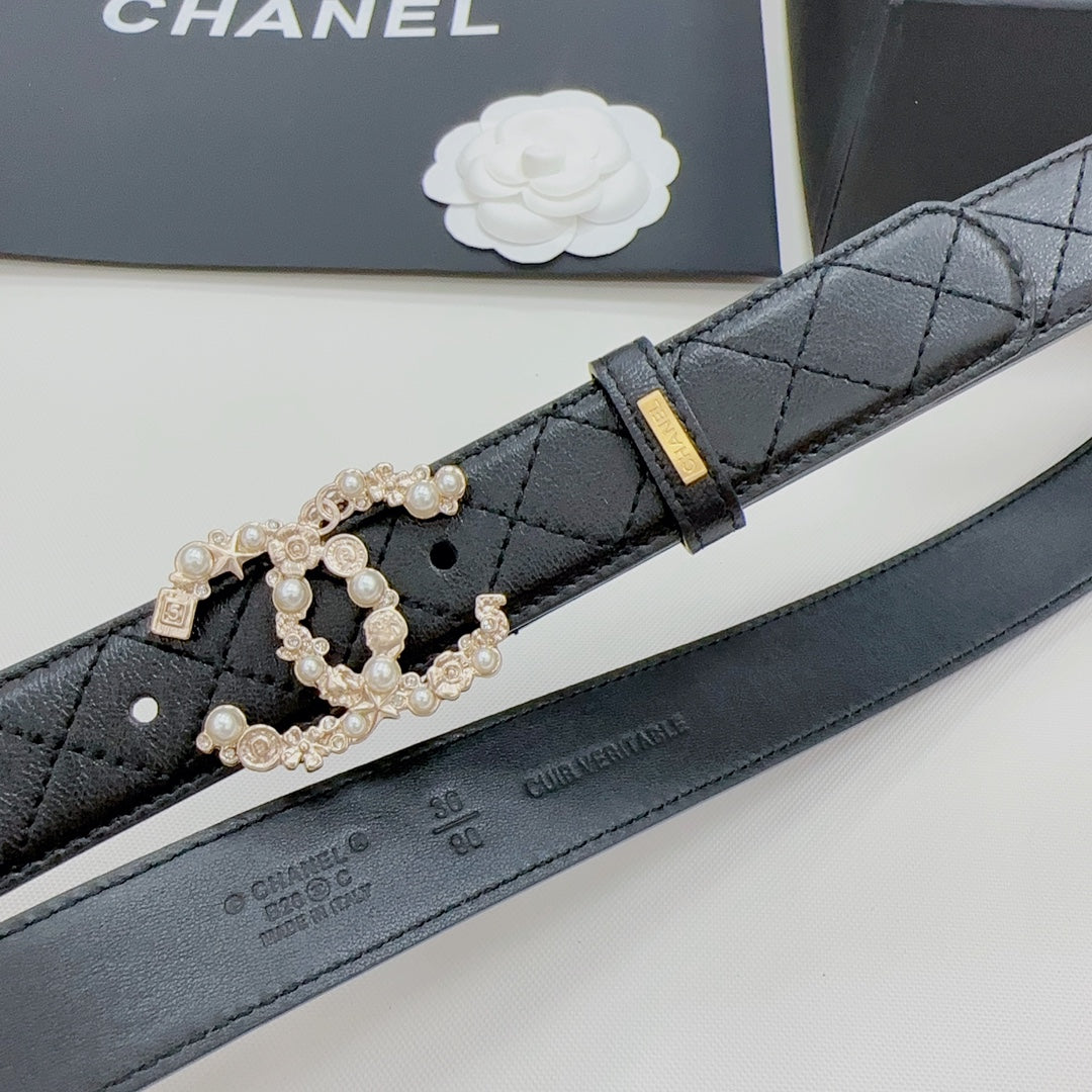 Chanel belt detail: dark quilted leather with gold buckle and pearl-embellished clasp