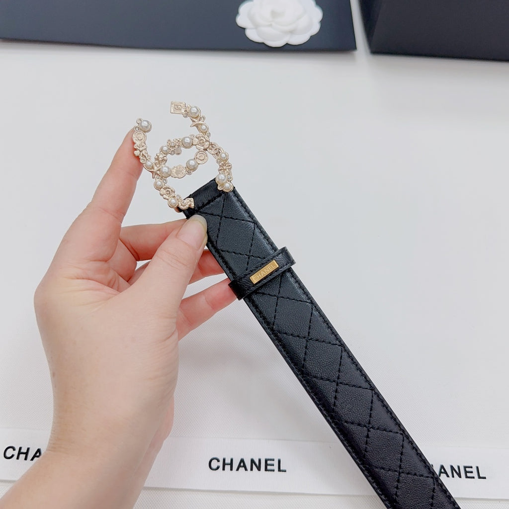 Chanel belt buckle detail: dark quilted strap with gold buckle and pearl floral frame