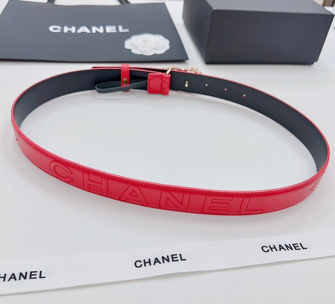 Chanel red quilted leather belt with embossed CHANEL lettering and gold buckle