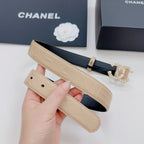 Beige Chanel belt with gold buckle, quilted texture, and rhinestone CC ornament