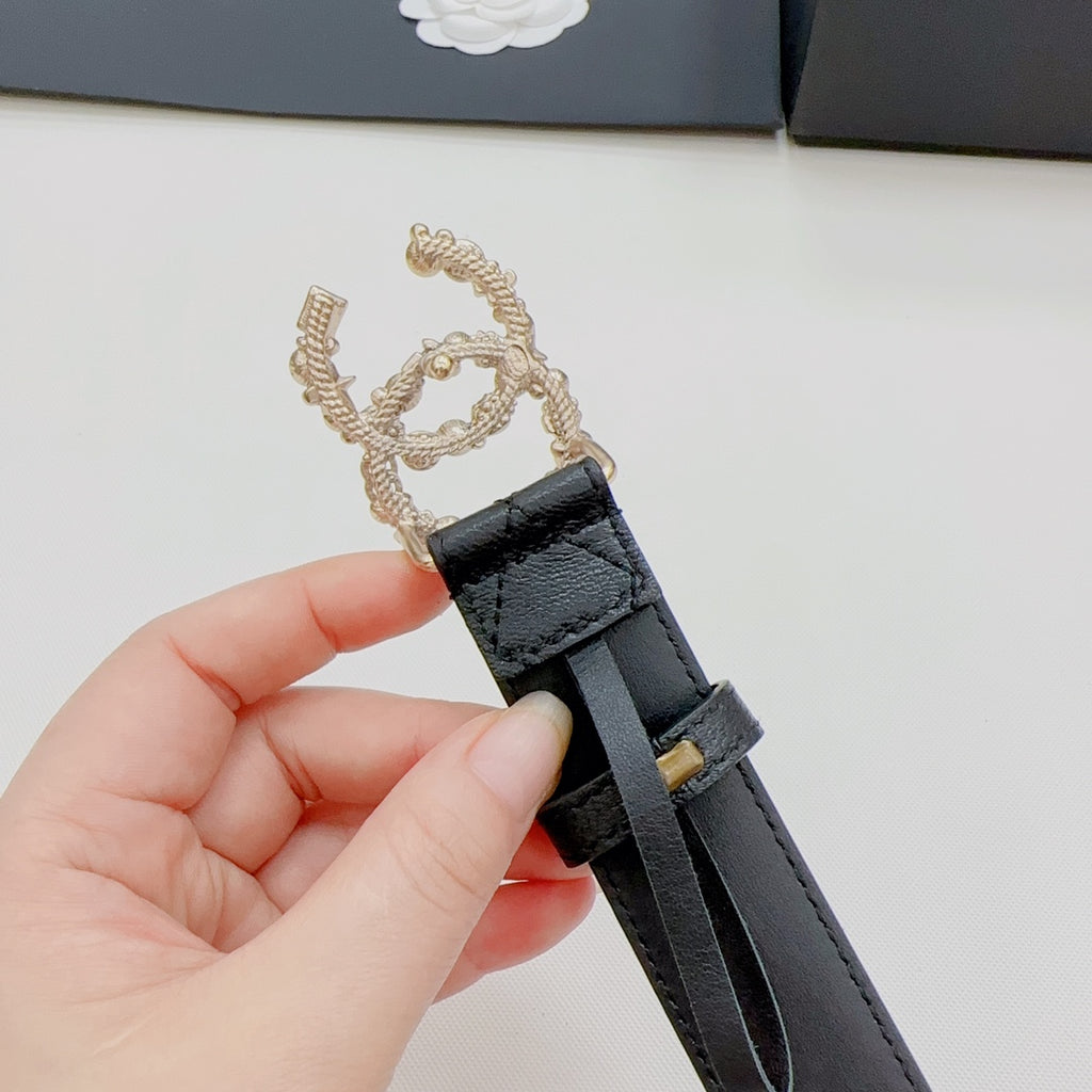 Chanel belt end close-up: dark leather strap with gold-tone buckle and decorative loop