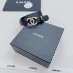 Chanel belt, dark blue with embossed letters; gold-tone buckle and pearl-like ornament