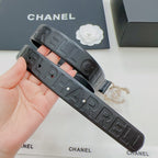 Chanel belt side view: dark blue embossed strap with gold buckle and decorative clasp