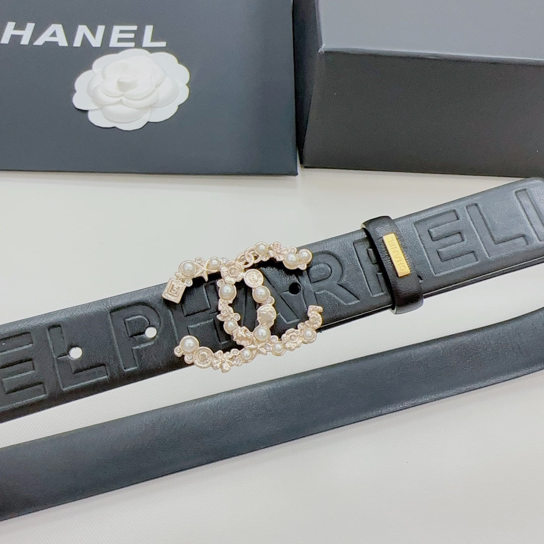 Chanel belt detail: dark blue embossed strap with gold-tone buckle and pearl-like interlock