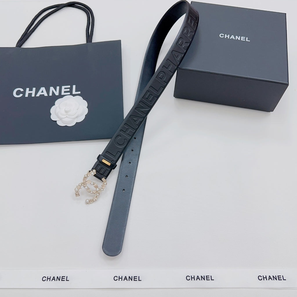 Chanel belt with embossed dark blue strap, gold-tone buckle, and dangling charm end