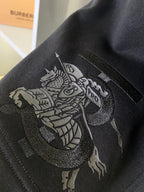 Black Burberry shorts with detailed embroidered lion crest graphic