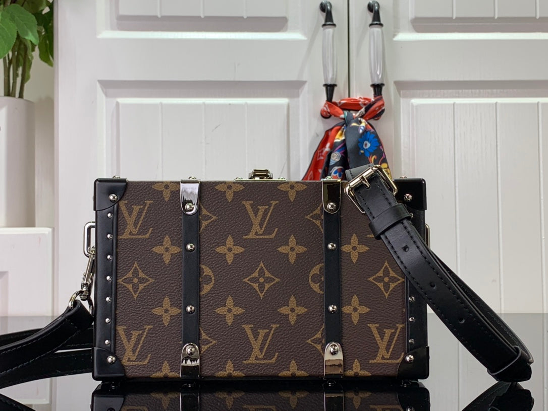 Louis Vuitton monogram bag with black leather strap and silver corner studs