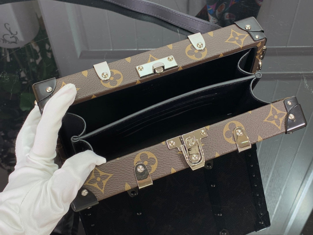 Louis Vuitton monogram top handle bag open with black interior and silver buckles