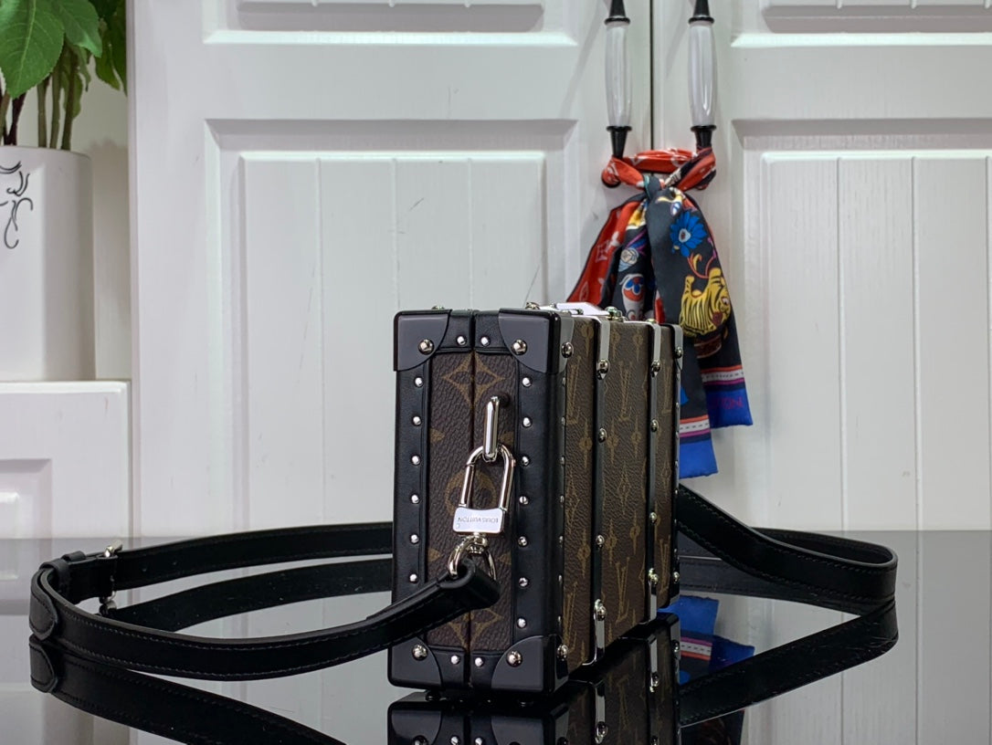 Louis Vuitton monogram bag with studded hardware and black crossbody strap