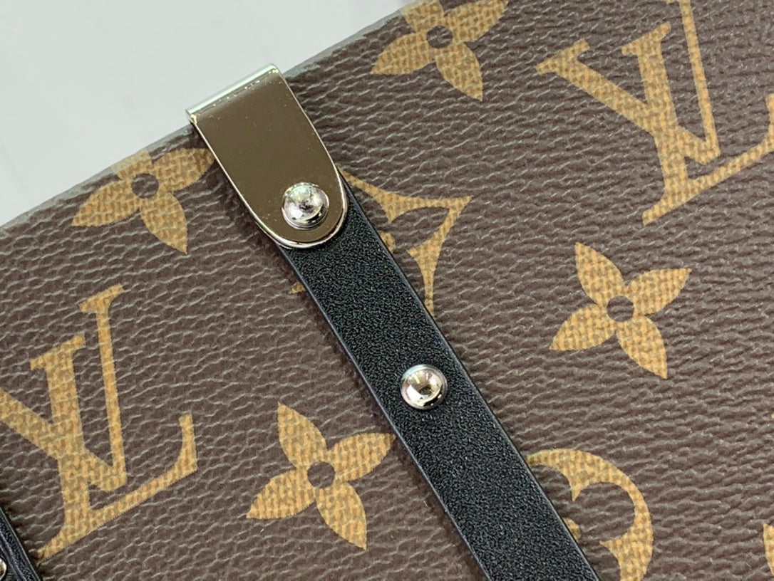 Louis Vuitton monogram bag strap tab with black leather patch and silver rivets