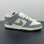 Light blue and white low-top sneakers with Nike swoosh and white lace-up