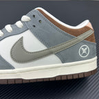 Side profile of light blue and white low-top sneakers with Nike swoosh and logo patch