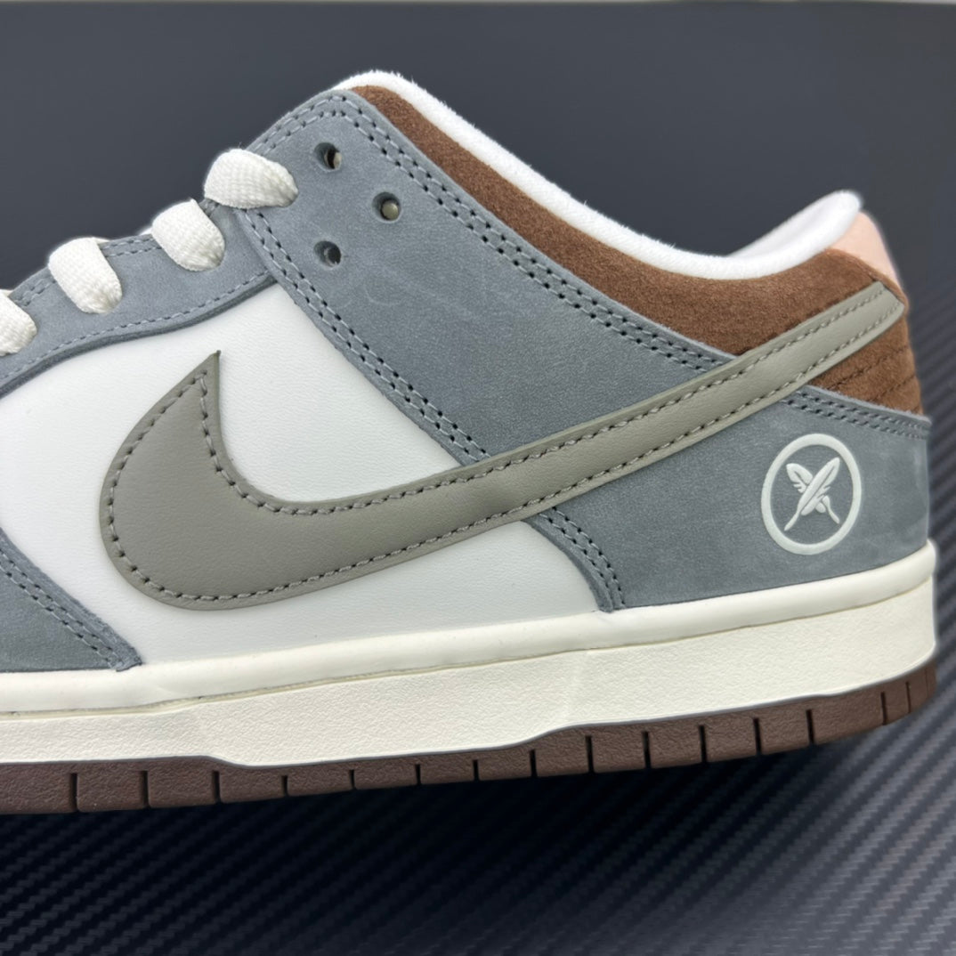 Side profile of light blue and white low-top sneakers with Nike swoosh and logo patch